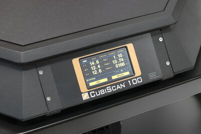The display of the CubiScan 100 shows length, width, height, and weight.