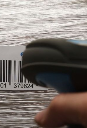 In the hand is a barcode scanner that scans an AKL-tec code