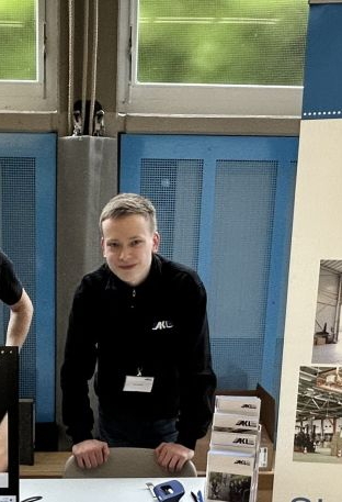 Two young men at a booth at the training fair in Daaden