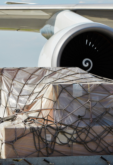 Packages under a net in front of an aircraft turbine