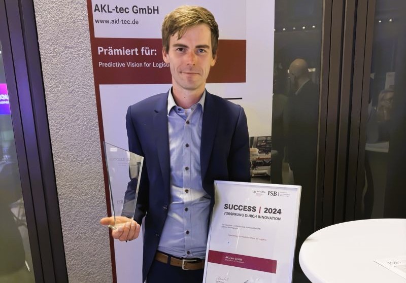 Maikel Boerebach holding a trophy and certificate at the Predictive Vision for Logistics 2024 awards ceremony
